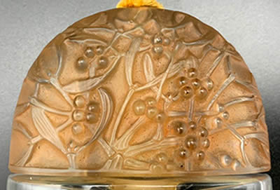 Sous Le Gui Perfume Bottle Elongated Dome Shaped Cover Designed By André Jolivette In 1924 for Jean De Parys Side 1 of 2 later replaced by a more refined and coherent René Lalique Cover In 1926 Sous Le Gui Perfume Bottle Elongated Dome Shaped Cover Designed By André Jolivette In 1924 for Jean De Parys Side 1 of 2 later replaced by a more refined and coherent René Lalique Cover In 1926
